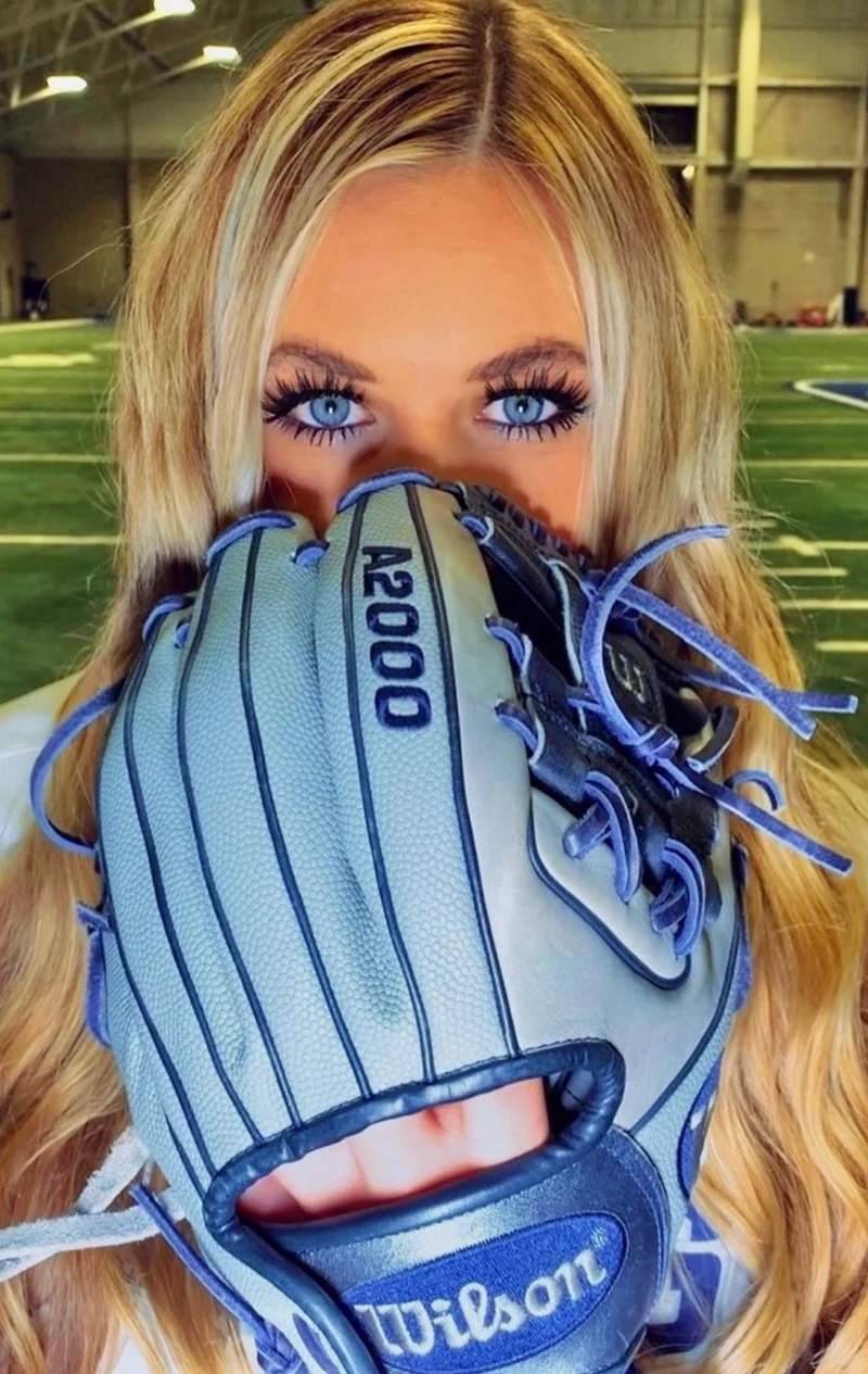 Close-up portrait with a light blue softball glove